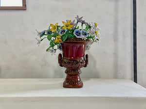 a close up of a vase with flowers in it 