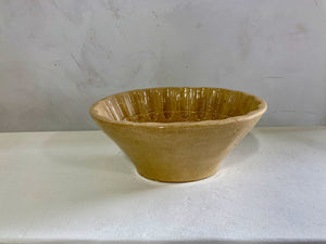 a white bowl sitting on top of a white table 